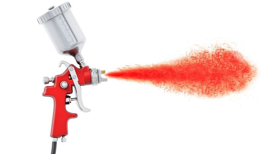A spray gun blowing out paint